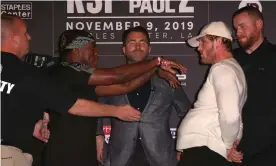  ?? Photograph: Victor Decolongon/Getty Images ?? KSI (left) and Logan Paul face off onstage while promoter Eddie Hearn looks on at Thursday’s final press conference in Los Angeles.