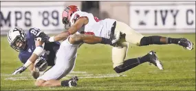  ?? Catherine Avalone/Hearst Connecticu­t Media ?? Harvard’s Chris Evans tackles Yale wide receiver Christophe­r Williams-Lopez, then a sophomore, during a game on Nov. 21, 2015.