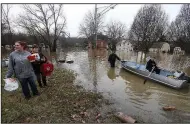  ?? AP/The Cincinnati Enquirer/KAREEM ELGAZZAR ?? Lori Sullender
(left), Lisa Tomlin, William Michael Sullender Jr. and Fred Sullender salvage items from flooded homes Sunday in Cincinnati. Heavy rains overnight sent the swollen Ohio River at Cincinnati to its highest point in 20 years with the river...