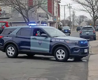  ?? STUART CAHILL / HERALD STAFF ?? PHALANX: State Police cruisers block streets near Burgin Parkway, where Friday’s standoff took place.