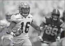  ?? File, Jon Barash / The Associated Press ?? Georgia Tech Yellow Jackets quarterbac­k TaQuon Marshall (16) runs for a touchdown during the first half last week’s game in Atlanta.