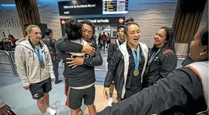  ?? LAWRENCE SMITH/STUFF ?? The New Zealand women’s sevens team was welcomed home in Auckland yesterday by family and friends after their World Cup win in San Francisco on Sunday.