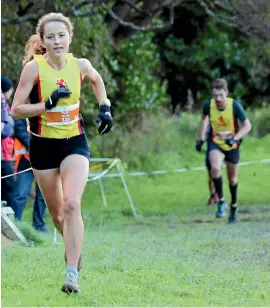  ?? PHOTO: JO MURRAY ?? Wellington Scottish runner Ruby Muir finishes the 10km race at the Vosseler Shield last Saturday as 2016 senior men’s winner Tim Hodge runs up the hill behind her.