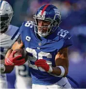  ?? Adam Hunger/Associated Press ?? New York Giants running back Saquon Barkley runs with the ball against the Indianapol­is Colts during a game on Jan. 1 in East Rutherford, N.J.