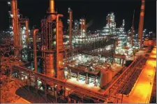  ?? DING HAITAO / XINHUA ?? A night view of the Yongping refinery at Yanchang Petroleum Group in Yan’an, Shaanxi, in 2005.