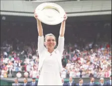  ??  ?? Simona Halep holds the Wimbledon Trophy aloft. (Reuter’s photo)