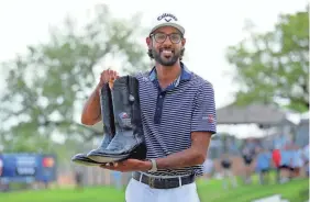  ?? ERIK WILLIAMS/USA TODAY SPORTS ?? Akshay Bhatia shows off the pair of boots prize after winning the Valero Texas Open title in a playoff Sunday.