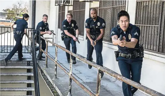  ?? — CBS ?? S.W.A.T. stars Moore (second from right) as a locally born and raised S.W.A.T. sergeant newly tasked to run a specialise­d tactical unit that is the last stop in law enforcemen­t in Los Angeles.