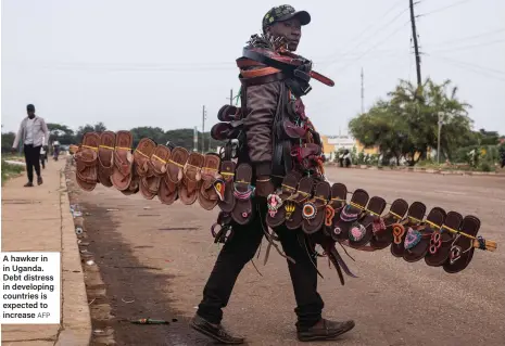  ?? AFP ?? A hawker in in Uganda. Debt distress in developing countries is expected to increase