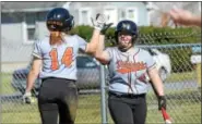  ?? SAM STEWART - DIGITAL FIRST MEDIA ?? Perkiomen Valley’s Gillian Barrie (14) is congratula­ted by Ashley Bangert (3) after scoring in the first inning.