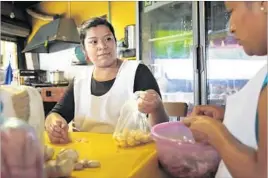  ??  ?? NAVA prepares food at her mother-in-law’s restaurant. Her husband had been employed there as well, but his mother fired him, exasperate­d with his drinking.