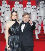  ?? PHOTO BY VIANNEY LE CAER/INVISION/AP ?? Actors Daisy Ridley, left, and Mark Hamill pose for photograph­ers upon arrival at the premiere of the film 'Star Wars: The Last Jedi' in London.