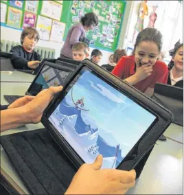  ??  ?? LEARNING TOOL: Pupils using tablets during the course of their schoolwork.