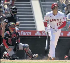  ?? PHOTOS BY MARK J. TERRILL — THE ASSOCIATED PRESS ?? The Angels’ Shohei Ohtani, Red Sox catcher Christian Vazquez and home plate umpire Adam Beck watch Ohtani’s fifth-inning home run Wednesday at Angel Stadium.