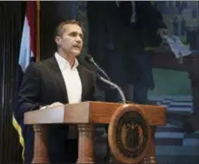  ?? JULIE SMITH/THE JEFFERSON CITY NEWS-TRIBUNE VIA AP ?? Missouri Gov. Eric Greitens reads from a prepared statement as he announces his resignatio­n during a news conference, Tuesday, at the state Capitol, in Jefferson City, Mo. Greitens resigned amid a widening investigat­ion that arose from an affair with...