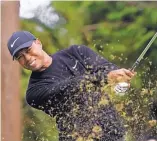  ?? LEE-JIN MAN/ ASSOCIATED PRESS ?? Tiger Woods watches his tee shot on the 13th hole during the first round of the Zozo Championsh­ip Thursday. Woods shot a 6-under 64 to take an early lead. Rain has washed out Friday’s round.