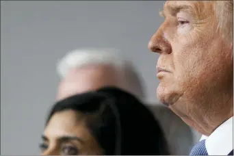  ?? EVAN VUCCI — THE ASSOCIATED PRESS ?? President Donald Trump and Administra­tor of the Centers for Medicare and Medicaid Services Seema Verma listen during a press briefing with the coronaviru­s task force, in the Brady press briefing room at the White House, Monday, March 16, 2020, in Washington.