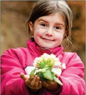  ??  ?? FLOWER GIRL: A child with a primrose posy