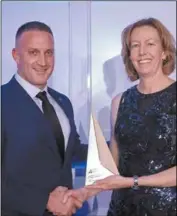  ??  ?? AMMA board member and Woodside chief operating officer Meg O’Neill presents the Contractor Workforce excellence award to Pilbara Resource Group director Scott Dryland.