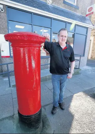  ??  ?? Postmaster Gavin Richards outside the new frontage of the post office