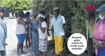  ??  ?? Residents gather outside the murder scene yesterday.