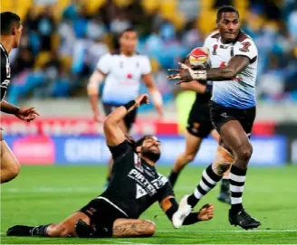  ??  ?? Divine: Fiji on their winning quarter-final way against the Kiwis.