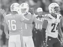  ??  ?? Kicker Cody Parkey (1) celebrates with punter and holder Matt Haack (16) after his 54-yard field goal with just over a minute left in Miami’s win.