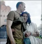  ?? The Associated Press ?? Stand-up comics Serhiy Lipko and Anastasia Zukhvala embrace during an interview with The Associated Press on their wedding day in Kyiv, Ukraine, Saturday.