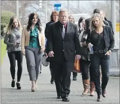  ?? ADRIAN LAM/VICTORIA TIMES COLONIST ?? Ken Noble, centre, with family and friends outside court in Victoria on Friday.