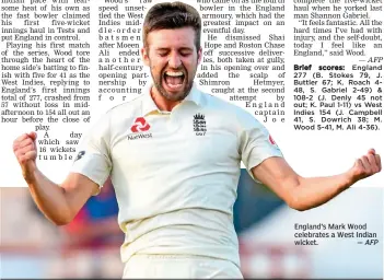  ?? — AFP ?? England’s Mark Wood celebrates a West Indian wicket.