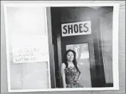  ?? Marilynn Montaño ?? A YOUNG WOMAN wearing a quinceañer­a gown poses in front of a closed shop in downtown, where trendy restaurant­s and boutiques continue to pop up.