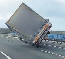  ?? FOTO: TWITTER/STEFAN KRAUTHOFF ?? Dieser Anhänger eines Lkw auf der Fleher Brücke (Autobahn 46) drohte im Sturm umzukippen und stand nur noch auf zwei Rädern.