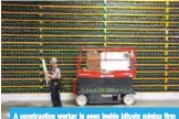  ??  ?? A constructi­on worker is seen inside bitcoin mining firm BitFarms in Saint Hyacinthe, Quebec on March 19, 2018.— AFP