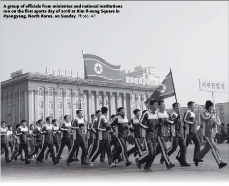  ?? Photo: AP ?? A group of officials from ministries and national institutio­ns run on the first sports day of 2018 at Kim Il-sung Square in Pyongyang, North Korea, on Sunday.