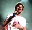  ??  ?? This file photo taken on December 1, 2015 shows Singer Louis Tomlinson of musical group One Direction performing onstage during 106.1 KISS FM's Jingle Ball 2015 presented by Capital One at American Airlines Center in Dallas, Texas.-AFP