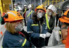  ?? ROBYN EDIE/STUFF ?? Prime Minister Jacinda Ardern at the official reopening of Potline 4 at Tiwai Point Aluminium smelter yesterday. From left, Energy Minister Megan Woods, Ardern, and list MP Liz Craig view aluminium just cast from the fourth potline, with NZAS staff.