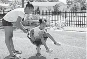  ??  ?? Keandra Russell, 13, plays with her sister, Kassidy Russell, 6, at B.F. James Park in Hallandale Beach on Wednesday.