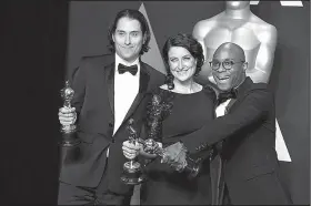  ?? AP/JORDAN STRAUSS ?? Jeremy Kleiner (from left), Adele Romanski and Barry Jenkins, winners of the Academy Award for best picture for Moonlight, pose Sunday at the Dolby Theatre in Los Angeles.