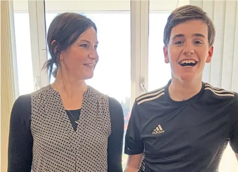  ??  ?? RECOVERY: Medics are amazed by brave schoolboy Wil Ritchie’s determinat­ion, pictured here with proud mum Karen.
