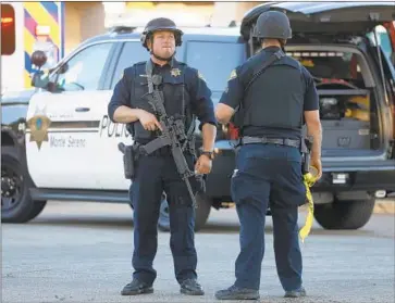  ?? Photograph­s by Nhat V. Meyer San Jose Mercury News ?? POLICE STAND GUARD after a mass shooting at the popular Gilroy Garlic Festival in Northern California. The festival was about to close Sunday evening when at least one gunman opened fire, authoritie­s said.