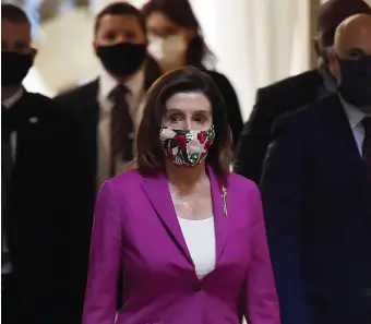  ?? GETTY IMAGES ?? POWER PUSH: House Speaker Nancy Pelosi stalks the halls of the U.S. Capitol in Washington, D.C., wearing a mask as she pushed through House passage of a record $3 trillion coronaviru­s response package on Friday. The measure is said to be dead on arrival in the Senate as Republican­s take a more cautious approach to additional aid.