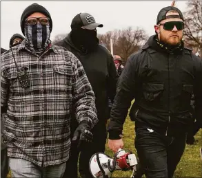  ?? Associated Press file photo ?? Proud Boys members Joseph Biggs, left, and Ethan Nordean, right with megaphone, walk toward the U.S. Capitol in Washington on Jan. 6, 2021.