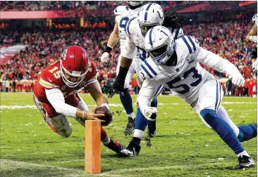  ?? JAMIE SQUIRE / GETTY IMAGES ?? Chiefs quarterbac­k Patrick Mahomes reaches the ball inside the pylon for a 4-yard touchdown run before Colts linebacker Darius Leonard (53) can stop him at snowy Arrowhead Stadium on Saturday.