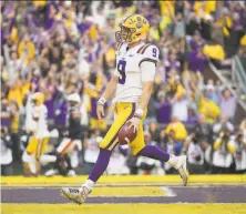  ?? Chris Graythen / Getty Images ?? LSU quarterbac­k Joe Burrow strolls into the end zone for a touchdown, part of his big day against Auburn.