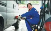  ?? LONG WEI / FOR CHINA DAILY ?? A worker fills up a van at a China Petrochemi­cal Corp gas station in Hangzhou, Zhejiang province.