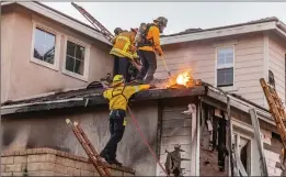  ?? Cory Rubin/The Signal ?? Firefighte­rs work to save a home on the 29500 block of Sequoia Road in Canyon Country during the Tick Fire early Friday morning.