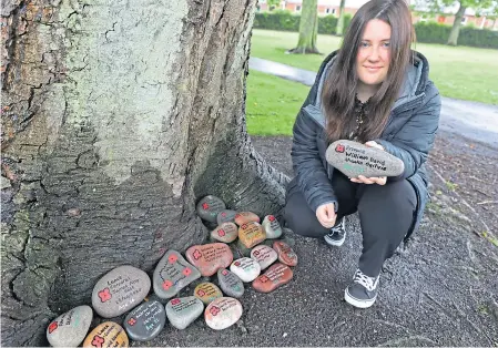  ??  ?? Eilidh beside some of her memorials in Hayswell Park, Arbroath.