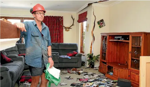  ?? PHOTO: DEREK FLYNN/FAIRFAX NZ ?? Kekerengu Road farmer Duncan Furniss inspects the damage to his dream home, which was condemned after the earthquake.