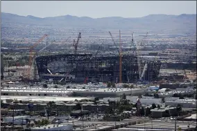  ?? JOHN LOCHER — THE ASSOCIATED PRESS ?? Constructi­on cranes surround a football stadium under constructi­on in Las Vegas in 2019.