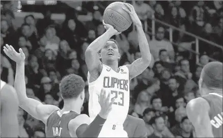  ?? Luis Sinco Los Angeles Times ?? LOU WILLIAMS, shooting over the Lakers’ Josh Hart, left, is questionab­le for Sunday’s game because of a sore right hamstring.